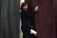 Anne Hidalgo, current Paris city deputy mayor and Socialist Party candidate in the mayoral election enters the voting booth before casting her ballot in Paris