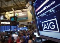 File photo of the American International Group, Inc. (AIG) stock ticker on a monitor as traders work on the floor of the New York Stock Exchange