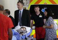 Ashya King, a 5-year-old British boy with a brain tumour, lies on a stretcher as he arrives with his  parents at the Motol hospital in Prague